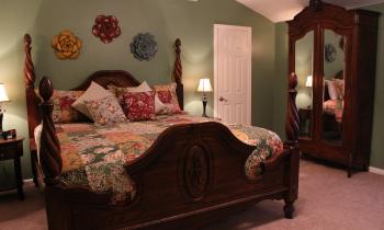 The four-poster bed and antique armoire just add to the warm atmosphere.